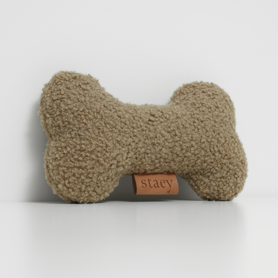 Bone-shaped dog toy in oat bouclé with an embossed Staey label