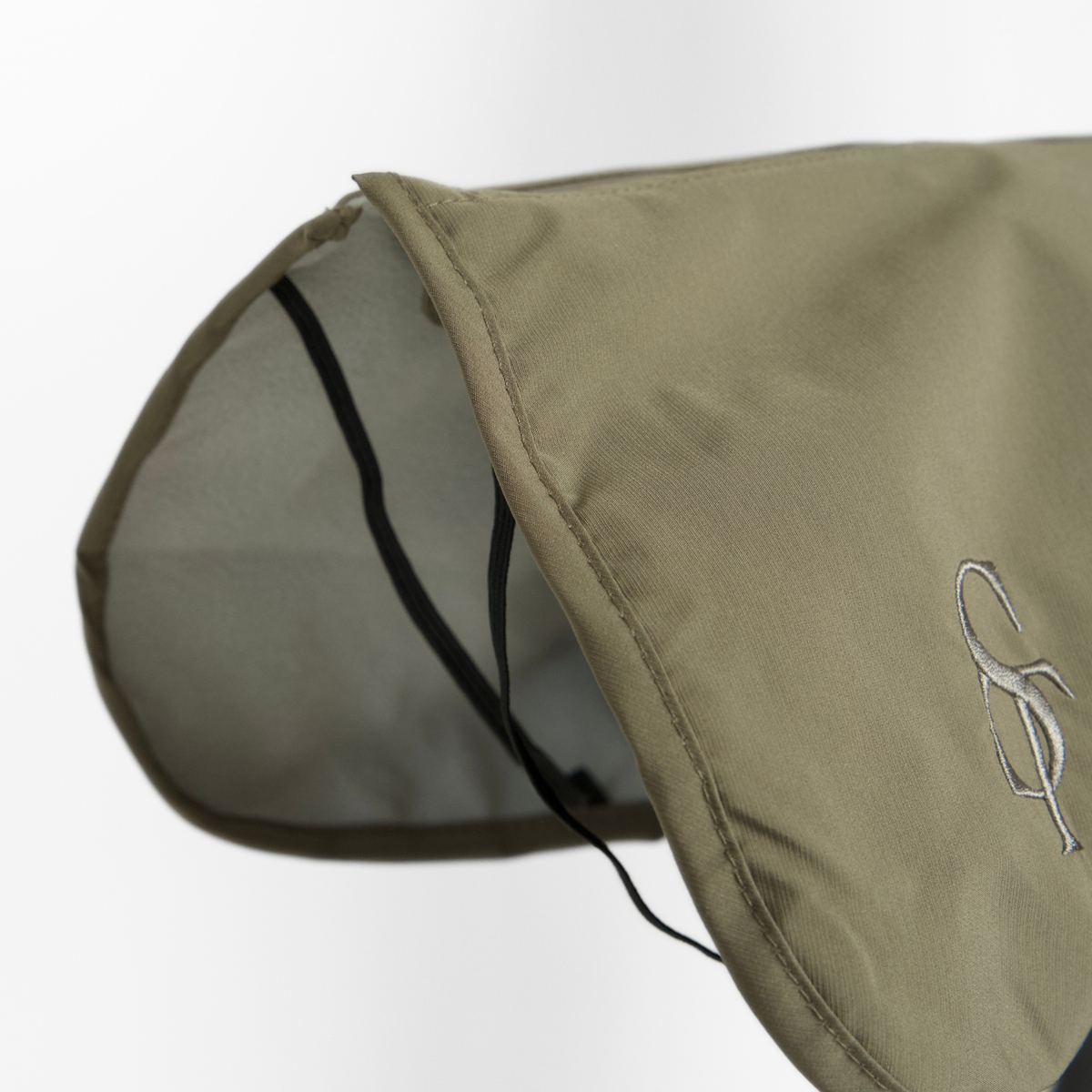 Close-up of the moss green rain coat collar with its grey lining