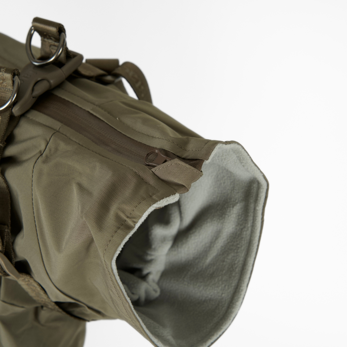 The moss green rain coat opened, showing its grey lining